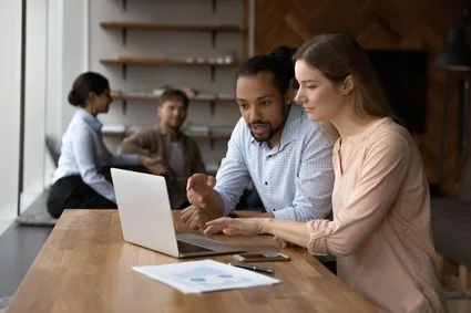 Man and woman working at laptop